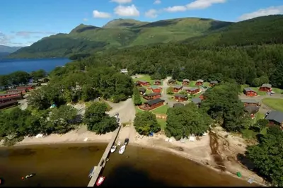 an aerial view of a resort with a lake and mountains at Lomond View Lodge in Glasgow