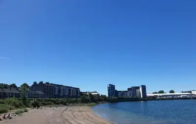 a view of a beach with buildings in the background at Comfortable Double Room, Great Transport to City Centre and Airport, 5 mins to Beach, Great Value in Edinburgh