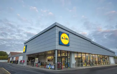 a store with a sign on the side of a building at Comfortable Double Room, Great Transport to City Centre and Airport, 5 mins to Beach, Great Value in Edinburgh