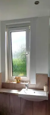 a bathroom with a sink and a window at Comfortable Double Room, Great Transport to City Centre and Airport, 5 mins to Beach, Great Value in Edinburgh