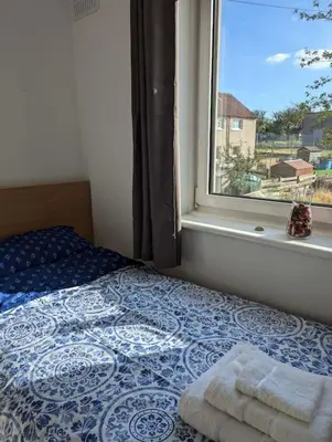 a bedroom with a bed and a window with a view at Lovely 3-Bed Edinburgh Flat in Edinburgh
