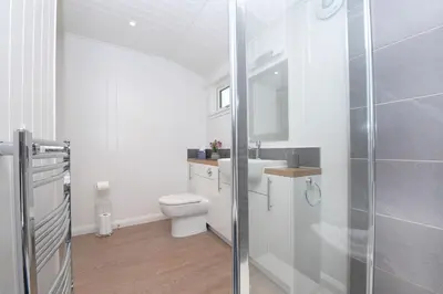 a bathroom with a toilet and a sink and a shower at Argyll View in Langbank