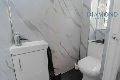 a bathroom with a white toilet and a sink at Brand New 4 Bedroom House - Sleeps 4 Fully Equipped, Free Parking, WiFi, Perfect for CONTRACTORS by Diamond Short Lets in Rosyth