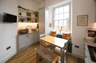 a kitchen and dining room with a table and chairs at Ayrbados - 4 bed townhouse in Ayr in Ayr