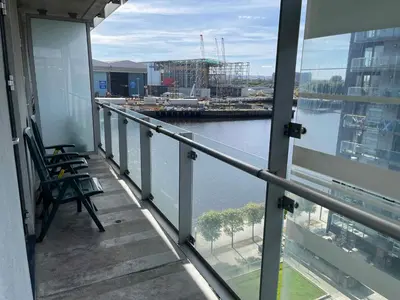 a balcony with a view of a body of water at Glasgow Harbour River West End in Glasgow