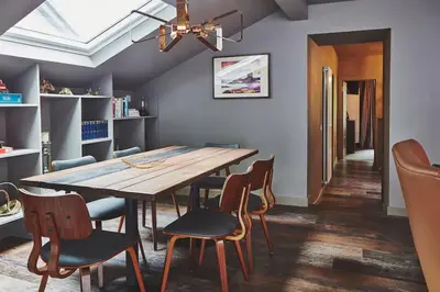 a dining room with a wooden table and chairs at Craig Chat in Oban