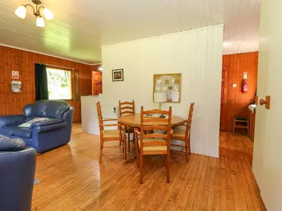 a living room with a table and chairs and a couch at Lodge 1 