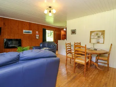 a living room with a blue couch and a table at Lodge 1 