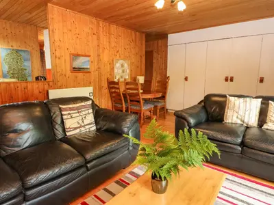 a living room with two leather couches and a table at Lodge 3 - 