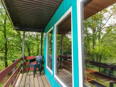 a screened in porch with a table and chairs on a deck at Lodge 3 - 