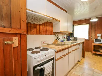 a kitchen with white appliances and wooden cabinets at Lodge 6 - 