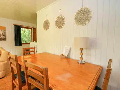 a dining room with a wooden table and chairs at Lodge 4 - 
