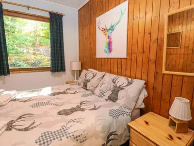 a bedroom with a bed and a window at Lodge 4 - 