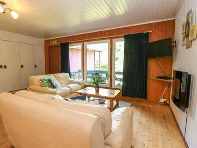 a living room with two white couches and a television at Lodge 4 - 