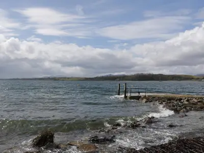 a view of a body of water with a pier at Tirlaggan House in Oban
