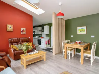 a living room with a couch and a table at Tirlaggan House in Oban