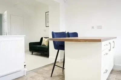 a kitchen with a counter and a green chair at Rhyber Avenue in Lanark