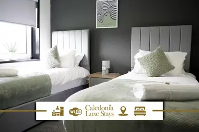 a hotel room with two beds and a window at Calgary House in Livingston