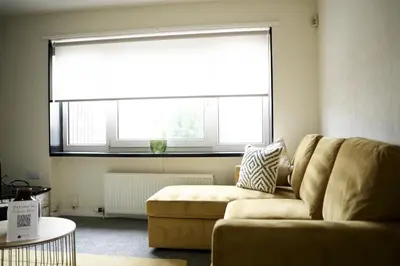 a living room with a couch and a large window at Calgary House in Livingston