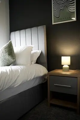 a bedroom with a bed with a lamp on a night stand at Calgary House in Livingston