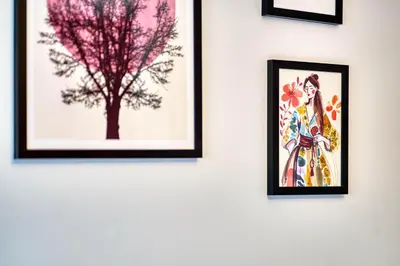 a group of framed pictures on a wall with a tree at Modern 2 Bed Flat with Free Parking in Glasgow