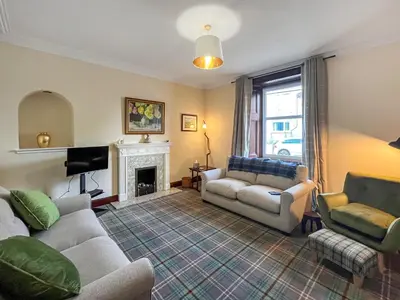 a living room with two couches and a fireplace at Arden in Glenluce