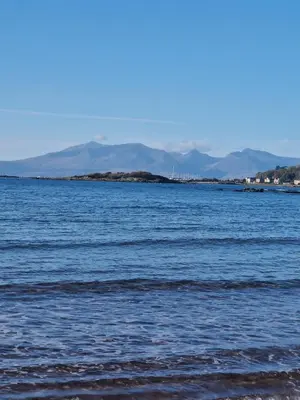 a large body of water with mountains in the background at Cumbrae Loft in Millport