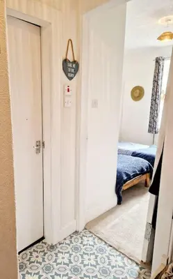 a hallway with a door leading to a bedroom at Cumbrae Loft in Millport