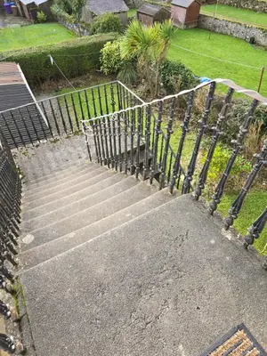a set of concrete stairs with a metal fence at Cumbrae Loft in Millport
