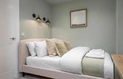 a white couch with pillows on it in a room at Central Stirling City Escape in Stirling