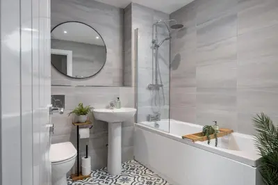 a bathroom with a sink and a tub and a toilet at Highland Hideaway Apartment in Stirling