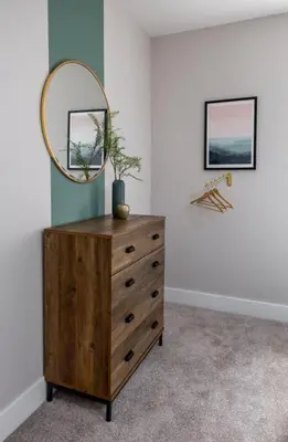 a dresser with a mirror on top of it at Highland Hideaway Apartment in Stirling
