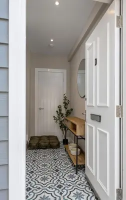 a door leading to a bathroom with a sink and a desk at Highland Hideaway Apartment in Stirling