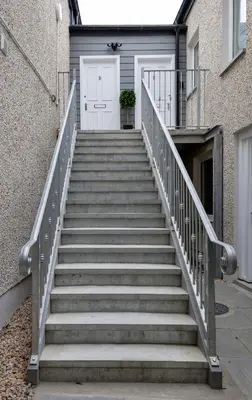 a set of stairs leading to a white door at Highland Hideaway Apartment in Stirling
