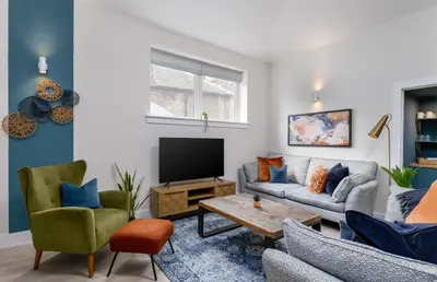 a living room with a couch and a tv at City Centre Haven Apartment in Stirling