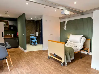 a hospital room with a bed and a kitchen at Modern Accessible Apartment with Interconnecting Room in Dolphinton