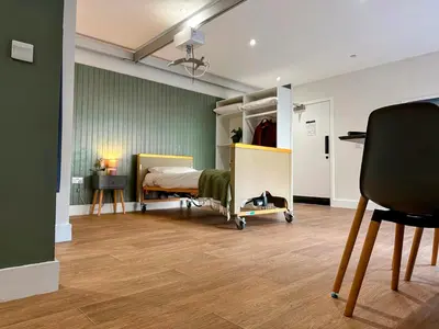 a bedroom with a bed and a desk and a chair at Modern Accessible Apartment with Interconnecting Room in Dolphinton