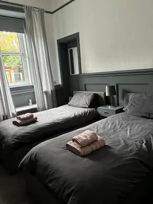 two beds sitting next to each other in a bedroom at Our Wee Eden - Rothesay in Rothesay