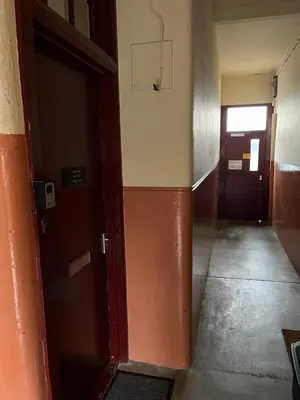 an empty hallway with a door and a basketball hoop at Our Wee Eden - Rothesay in Rothesay