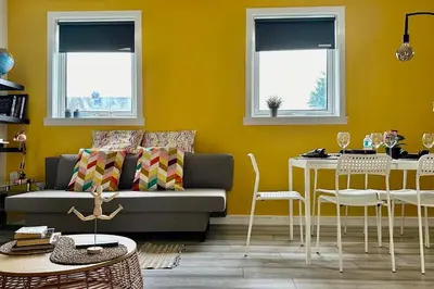 a living room with a couch and a table at Quite Charming house near Glasgow in Clydebank