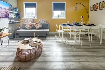 a living room with a table and a couch at Quite Charming house near Glasgow in Clydebank