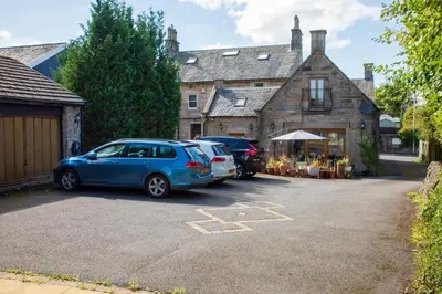 two cars parked in a parking lot in front of a house at The Banking Hall in Polmont