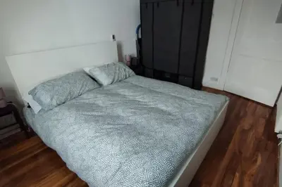 a small bed in a room with at Lovely flat near Glasgow in Barrhead