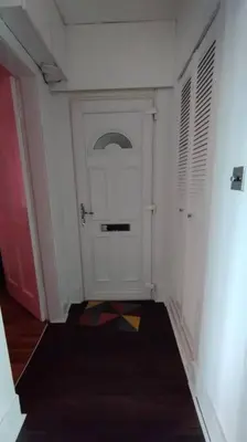 a hallway with a white door in a room at Lovely flat near Glasgow in Barrhead