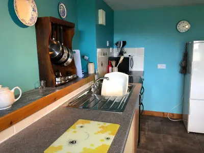 a kitchen with a sink and a counter with a stove at Little cottage-Village of Bunessan-Sleeps4 in Bunessan