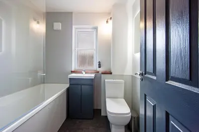 a bathroom with a toilet and a tub and a sink at Exceptional 2BD Apt - next to ferry & train station in Oban