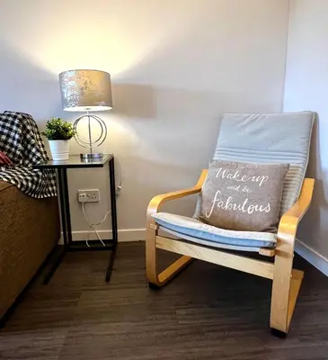 a chair with a pillow that reads make up and a fabulous at Cityview Retreat - 2-Bed Apartment - Free Parking in Glasgow