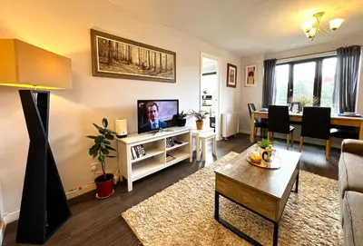 a living room with a television and a dining room at Cityview Retreat - 2-Bed Apartment - Free Parking in Glasgow