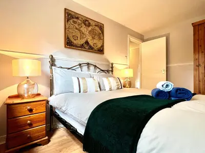 a bedroom with two beds with a green blanket at Cityview Retreat - 2-Bed Apartment - Free Parking in Glasgow