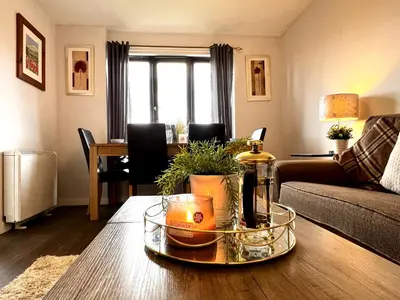 a living room with a table with a bottle of wine at Cityview Retreat - 2-Bed Apartment - Free Parking in Glasgow